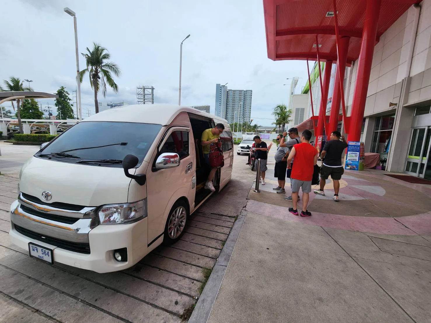 Passengers arriving by private VIP van at an airport terminal
