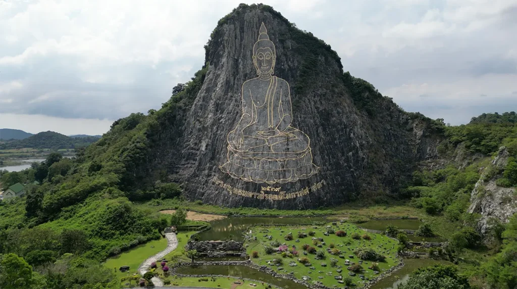 Laser-engraved golden Buddha image on the cliff of Khao Chi Chan mountain in Pattaya, Thailand.