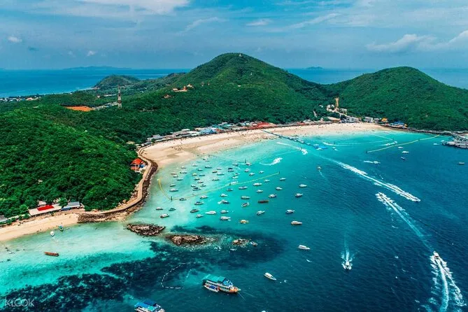 Aerial panoramic view of Tawaen Beach on Koh Larn island with turquoise water and many speedboats near Pattaya.
