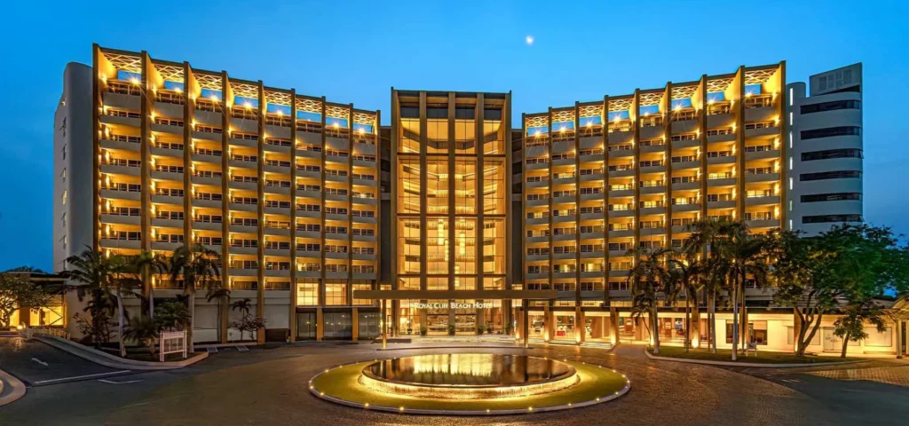 Grand illuminated exterior of the Royal Cliff Beach Hotel in Pattaya at twilight, featuring its stunning modern architecture and entrance.