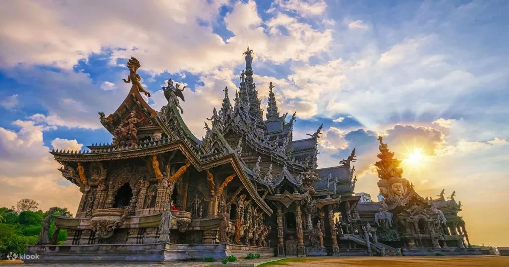 Stunning aerial view of the Sanctuary of Truth wooden temple on the coast with Pattaya city skyscrapers in the background.