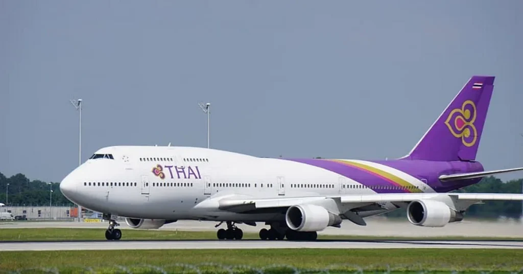 Thai Airways Boeing 747 passenger airplane taxiing on the airport runway during the daytime.