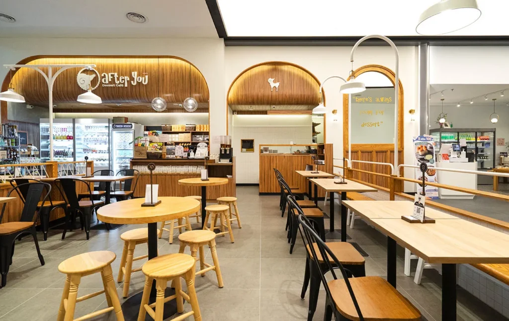 Cozy wooden interior and empty seating area of the popular After You Dessert Cafe on the G floor of Siam Paragon.