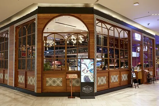 Elegant wooden facade and arched windows of Mozza by Cocotte Italian restaurant on the G floor of Siam Paragon.